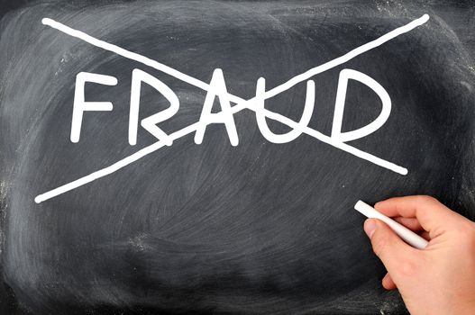 No fraud crossed out with chalk on a blackboard background