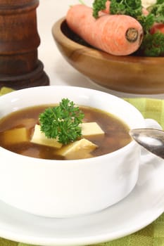 Beef consomme with fresh soup vegetables, egg and parsley