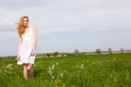 beautiful blonde woman outdoor in summer happy