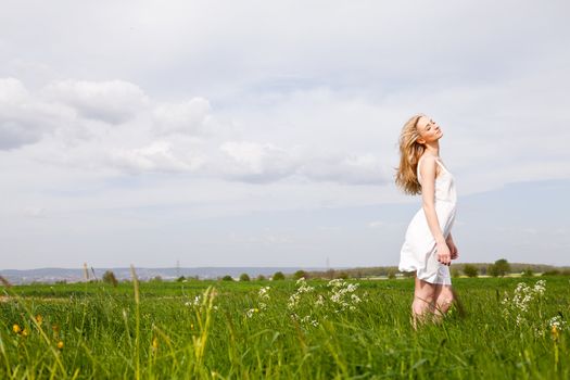 beautiful blonde woman outdoor in summer happy