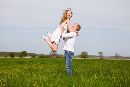 young happy couple have fun in summer outdoor in nature