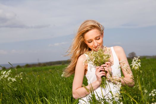 beautiful blonde woman outdoor in summer happy