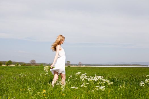 beautiful blonde woman outdoor in summer happy