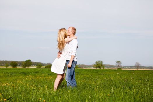 young happy couple have fun in summer outdoor in nature