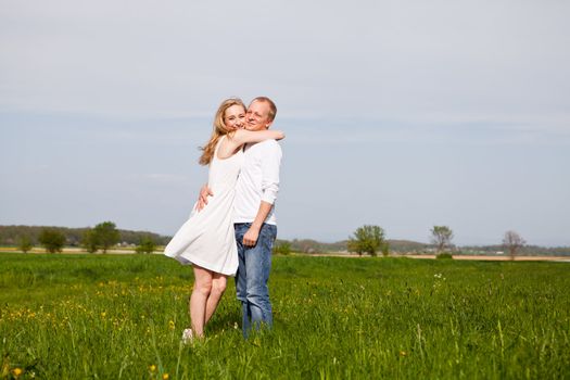 young happy couple have fun in summer outdoor in nature