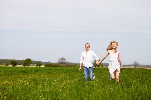 young happy couple have fun in summer outdoor in nature