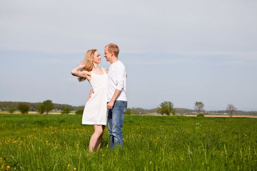 young happy couple have fun in summer outdoor in nature