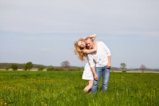 young happy couple have fun in summer outdoor in nature