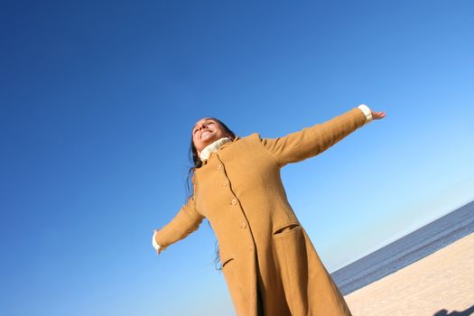 Portrait of a woman enjoying the sunlight on a beach.