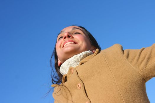 Portrait of a woman enjoying the sunlight on a beach.