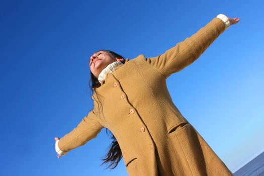 Portrait of a woman enjoying the sunlight on a beach.