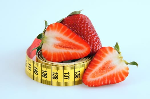 Fresh red tasty strawberries with measuring tape