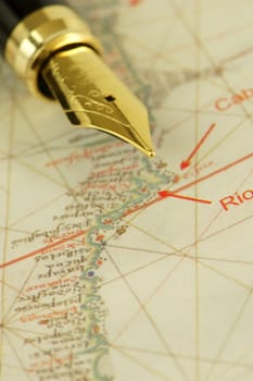 A nib pen on a fragment of an ancient nautical chart representing the coast of Brazil