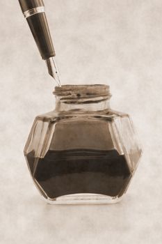 A fountain pen with inkwell in vintage style
