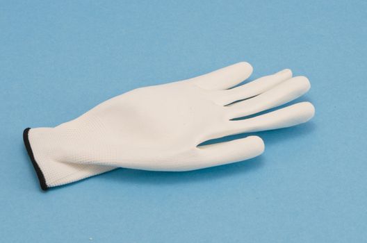White working glove on blue background. Object protect hand skin.