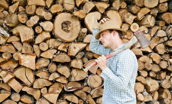 Woodcutter with straw hat on a background of wood