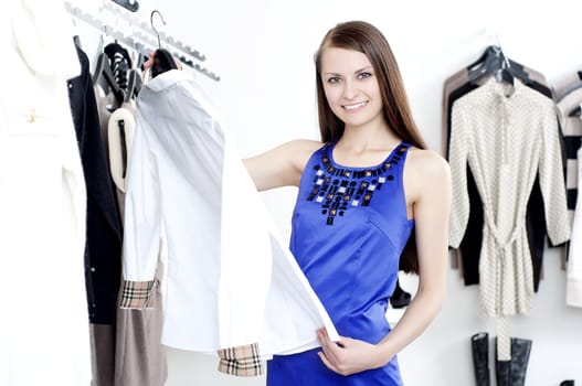 young Beautiful woman in mall buying clothes