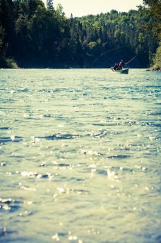 Fishermen fly fishing the salmon on a jolly-boat