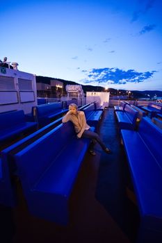 Girl sitting on the deck, the evening