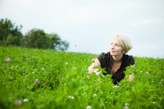 Girl in a field of flowers smiling