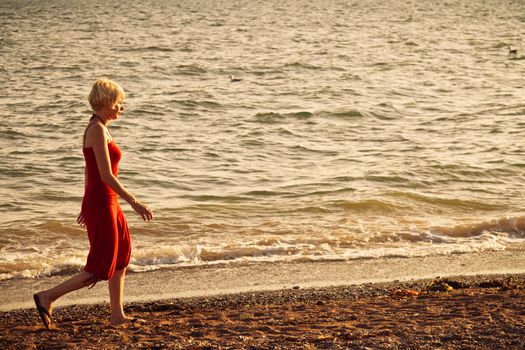 Girl walking along the beach - vintage look