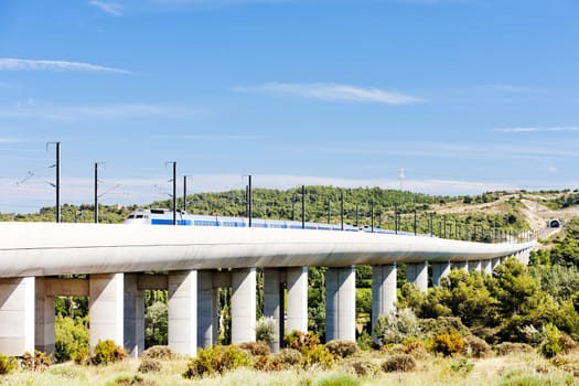 train of TGV on railway viaduct near Vernegues, Provence, France