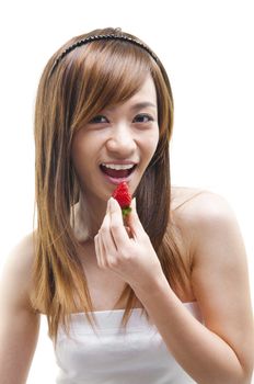 Young Asian teen eating strawberry on white background