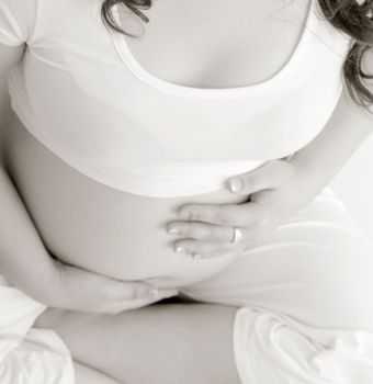 Asian pregnant lady meditating in sepia tone