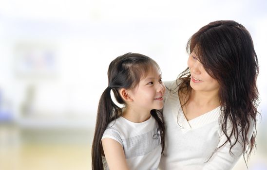 Asian mother and her daughter having conversation in home