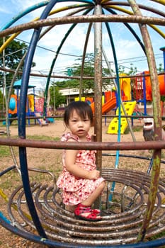 Asian Little girl playing in Playground of Thailand