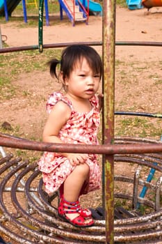 Asian Little girl playing in Playground of Thailand