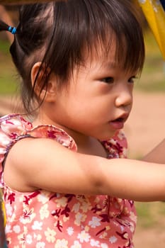 Asian Little girl playing in Playground of Thailand