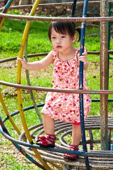 Asian Little girl playing in Playground of Thailand