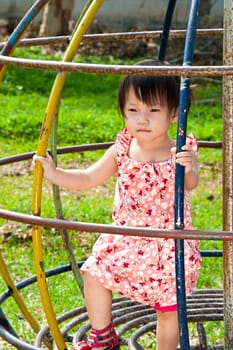 Asian Little girl playing in Playground of Thailand