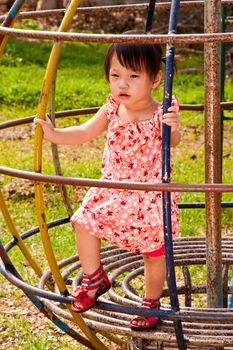 Asian Little girl playing in Playground of Thailand