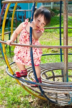 Asian Little girl playing in Playground of Thailand