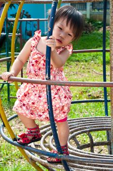 Asian Little girl playing in Playground of Thailand