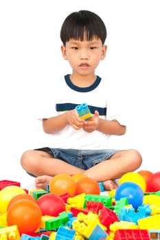 Little boy playing with toy on white background