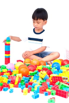 Little boy playing with toy on white background