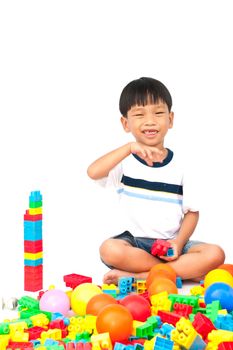 Little boy playing with toy on white background