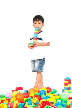 Little boy playing with toy on white background