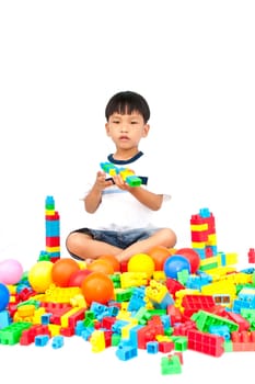 Little boy playing with toy on white background