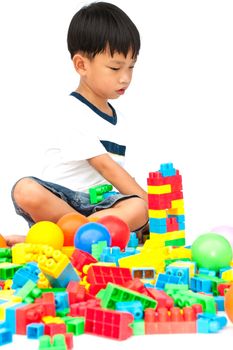 Little boy playing with toy on white background