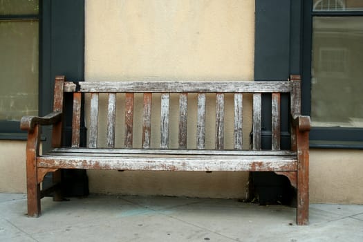 Old wodden bench on a sidwalk