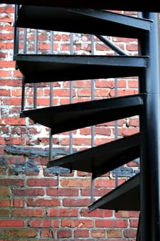 A Spiral staircase with brick wall