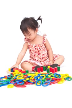 Little girl playing with toy on isolate background