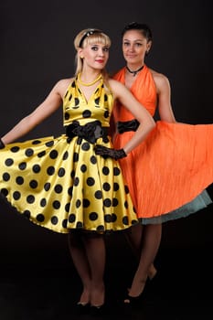 Young dancer women in retro dresses.