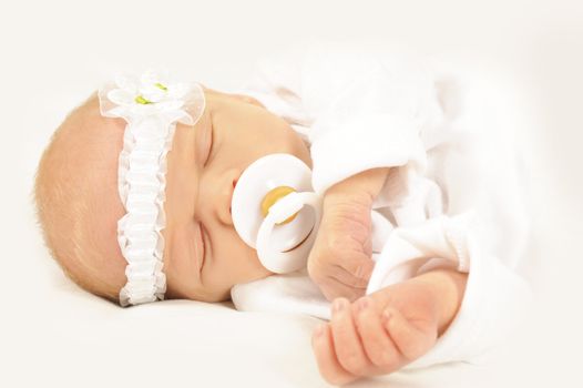 Adorable new born baby with head band on white