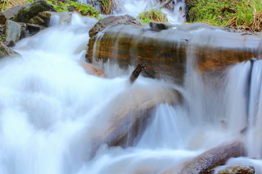 beautiful waterfall near the spring up in the mountains