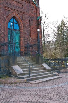 In front of a church with stairs to front door